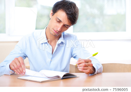 Businessman sitting indoors and writing plan in his diary Businessman sitting indoors and writing plan in his diary 7596005