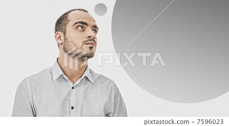 Portrait of adult businessman posing against grey background. Bl 7596023