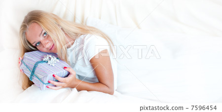 Bedroom surprise present - young happy woman in bedroom Bedroom surprise present - young happy woman in bedroom 7596454