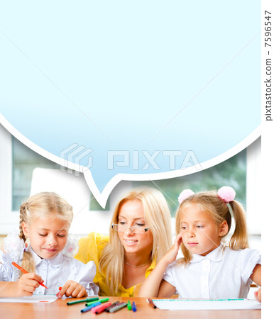 Young pretty teacher helping to her students to make exercise in Young pretty teacher helping to her students to make exercise in 7596547