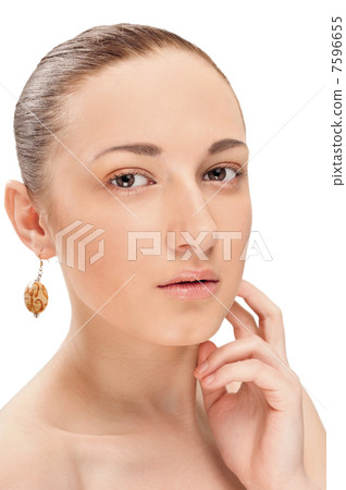 Portrait of a beautiful woman up-close and wearing an earing Portrait of a beautiful woman up-close and wearing an earing 7596655