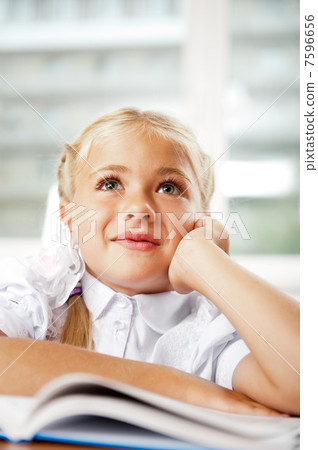 Image of smart child reading interesting book in classroom Image of smart child reading interesting book in classroom 7596656