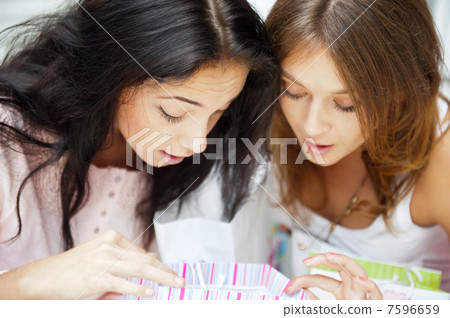 Two excited shopping woman together inside shopping mall laughin 7596659