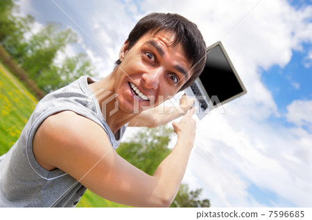 casual young man pointing at laptop screen casual young man pointing at laptop screen 7596685