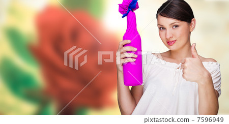 Portrait of young pretty woman holding bottle of prefect wine in 7596949