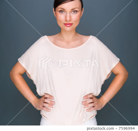Portrait of beautiful woman looking at camera and holding hands 7596994