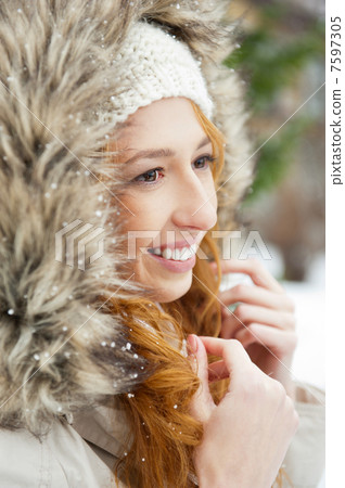 Portrait of pretty girl at winter background wearing warm clothe 7597305