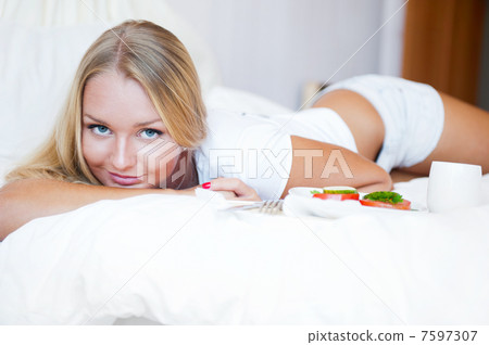 Woman having breakfast in bed. Healthy continental breakfast. Ca 7597307