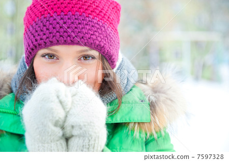 Winter woman in snow looking at camera outside on snowing cold w Winter woman in snow looking at camera outside on snowing cold w 7597328