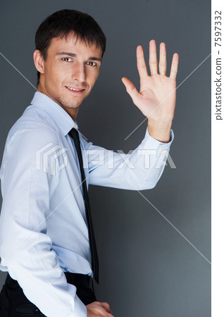 Closeup of a young smiling business man standing confidently aga Closeup of a young smiling business man standing confidently aga 7597332