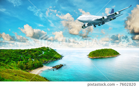 Jet plane over the tropical island. Panoramic composition in ver 7602820
