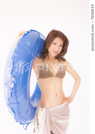 A woman in a bathing suit with a floating ring A woman in a bathing suit with a floating ring 7606634