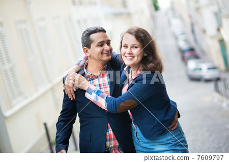 Cheerful couple hugging on the street Cheerful couple hugging on the street 7609797