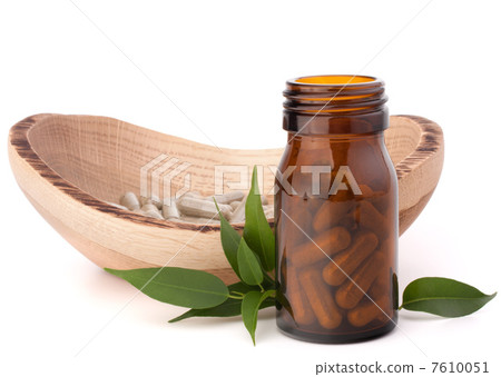 Herbal drug capsules in brown glass bottle. Alternative medicine 7610051