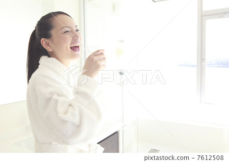 A woman drinking a glass of water A woman drinking a glass of water 7612508