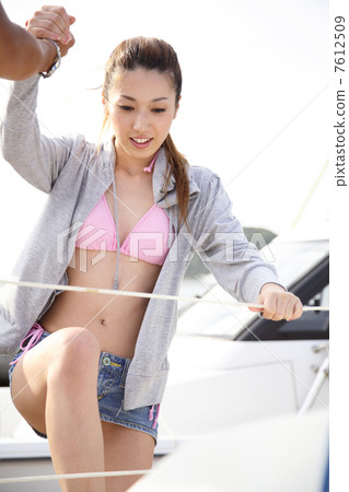 A woman riding a yacht A woman riding a yacht 7612509