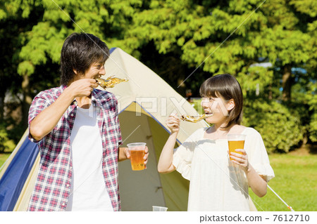 A couple eating barbecue ayu 7612710