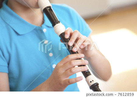 Elementary school girls playing recorder 7612859