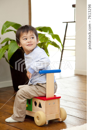 Boys playing on a wheelbarrow 7613296