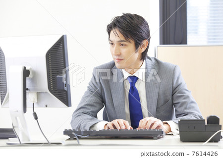 Businessman using a personal computer Businessman using a personal computer 7614426