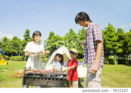 Family enjoying a barbecue Family enjoying a barbecue 7615287