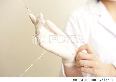 Female dentist wearing rubber gloves Female dentist wearing rubber gloves 7615694