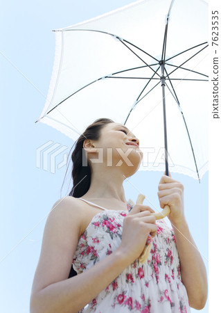 Summer blue sky and a young lady 7623535