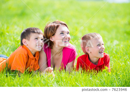 Young happy mother with children in park Young happy mother with children in park 7623946