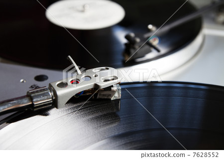 Turntable playing vinyl record with music 7628552