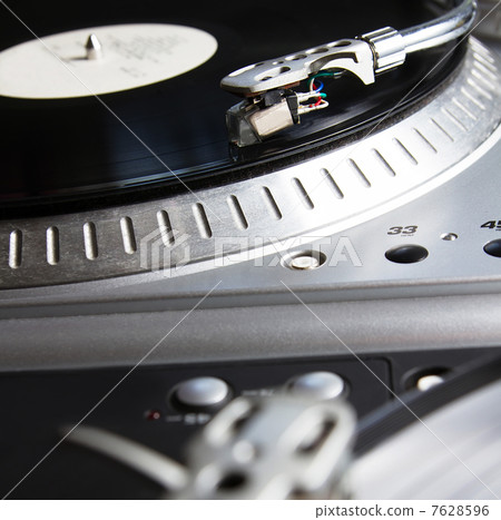 Turntable playing vinyl record with music 7628596