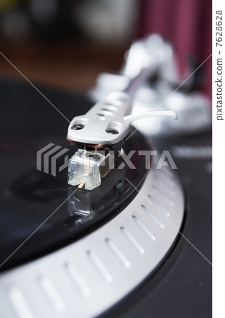 Turntable playing vinyl record with music 7628628