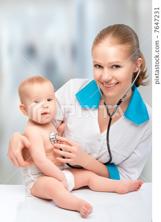 baby and doctor pediatrician. doctor listens to the heart with s 7647231
