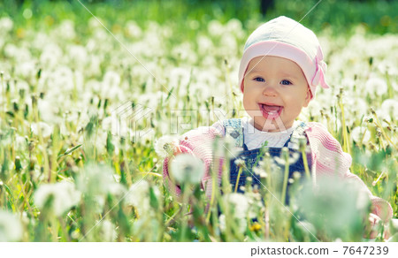 happy baby girl on meadow with white flowers on the nature happy baby girl on meadow with white flowers on the nature 7647239