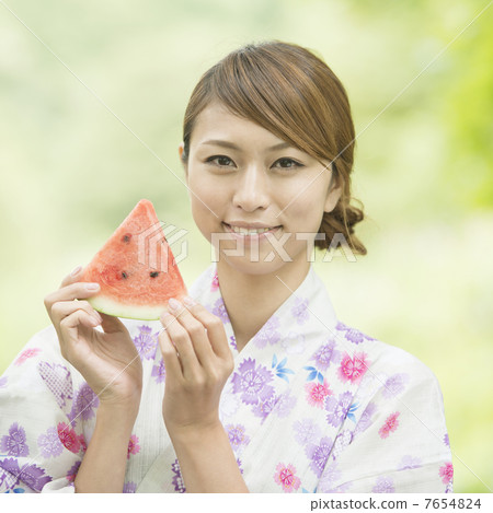 A woman in a yukata with a watermelon smile A woman in a yukata with a watermelon smile 7654824