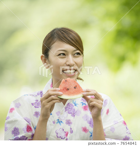 A woman in a yukata eating watermelon A woman in a yukata eating watermelon 7654841