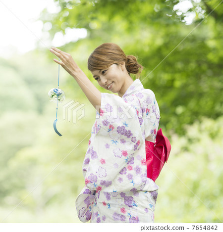A woman in a yukata with a wind chimes smile A woman in a yukata with a wind chimes smile 7654842