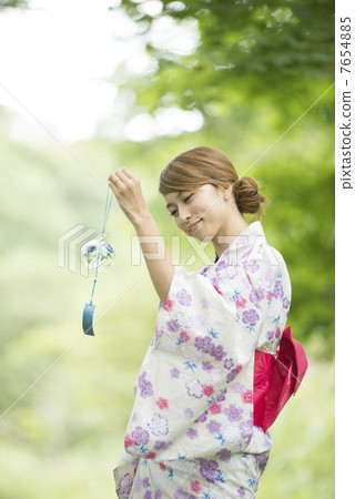 A woman in a yukata with a wind chimes smile A woman in a yukata with a wind chimes smile 7654885