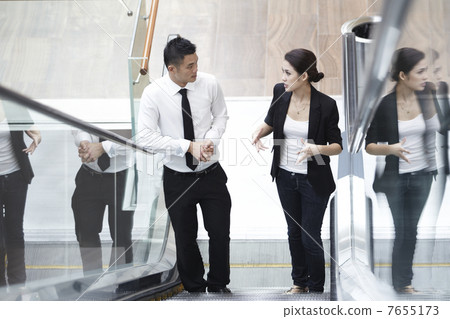 Businessman and Businesswoman talking 7655173