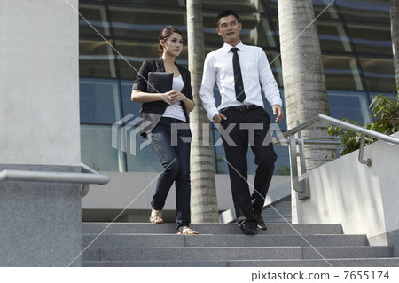 Asian Business Man and Woman Walking Down Steps 7655174