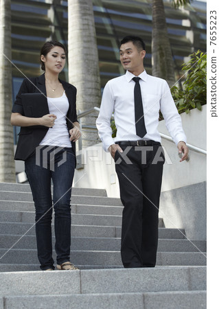 Asian Business Man and Woman Walking Down Steps Asian Business Man and Woman Walking Down Steps 7655223