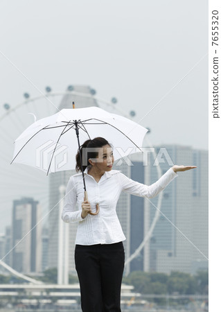 Asian business woman standing under an Umbrella Asian business woman standing under an Umbrella 7655320