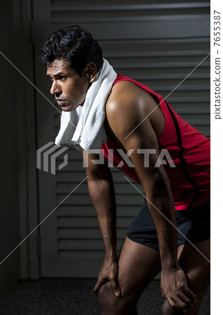Athletic Indian man resting after exercise. 7655387