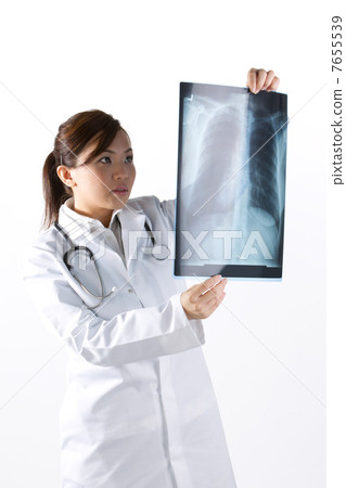 Portrait of a Female Doctor looking at an X-Ray. Portrait of a Female Doctor looking at an X-Ray. 7655539