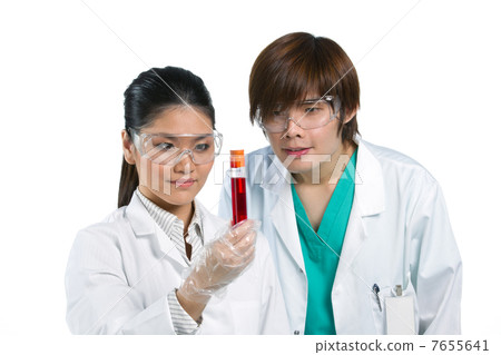 Two scientists analyzing solution. Two scientists analyzing solution. 7655641
