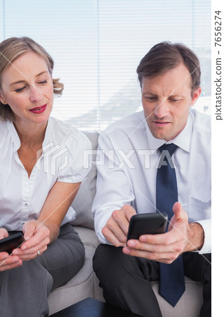 Business partners using their mobile phones 7656274