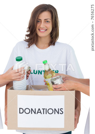 Smiling volunteer holding a food donation box 7656275
