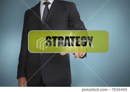 Businessman touching the word strategy written on green tag Businessman touching the word strategy written on green tag 7656469