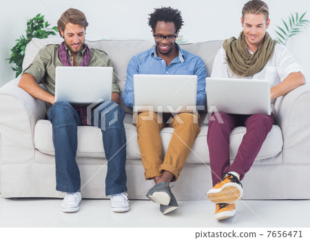 Handsome designers working with laptops Handsome designers working with laptops 7656471