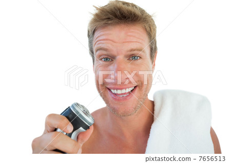 Handsome man holding an electric razor Handsome man holding an electric razor 7656513