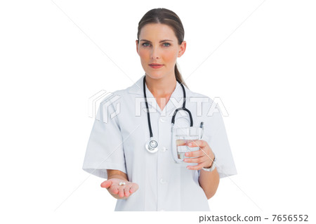 Smiling nurse holding medicine and glass of water Smiling nurse holding medicine and glass of water 7656552